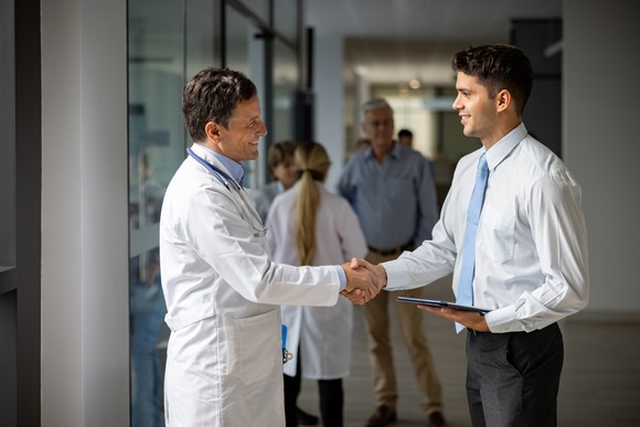 A businessman shaking a doctor's hand.