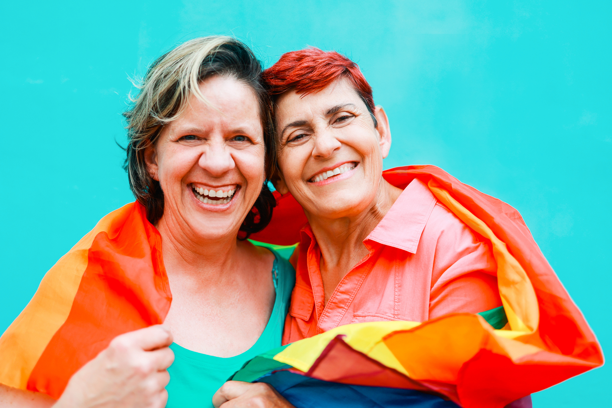 Getty - couple happy smiling rainbow flag