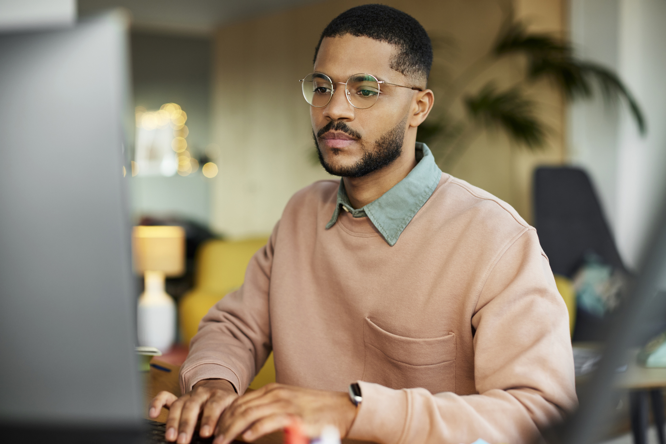 An investor works on a laptop in a home office.