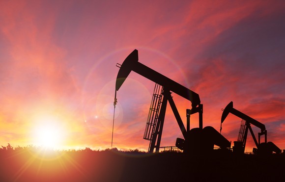 Oil derricks before a sunset. 