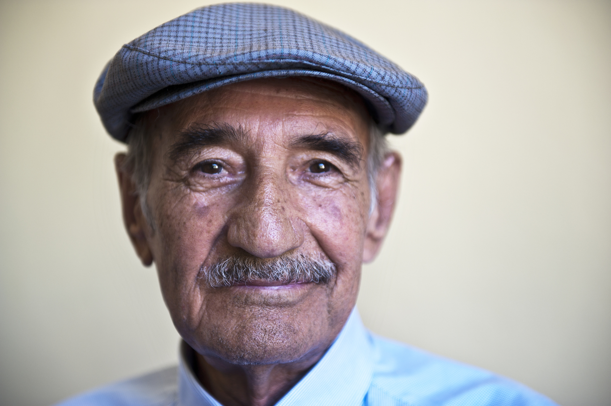 Someone in a cap, smiling.