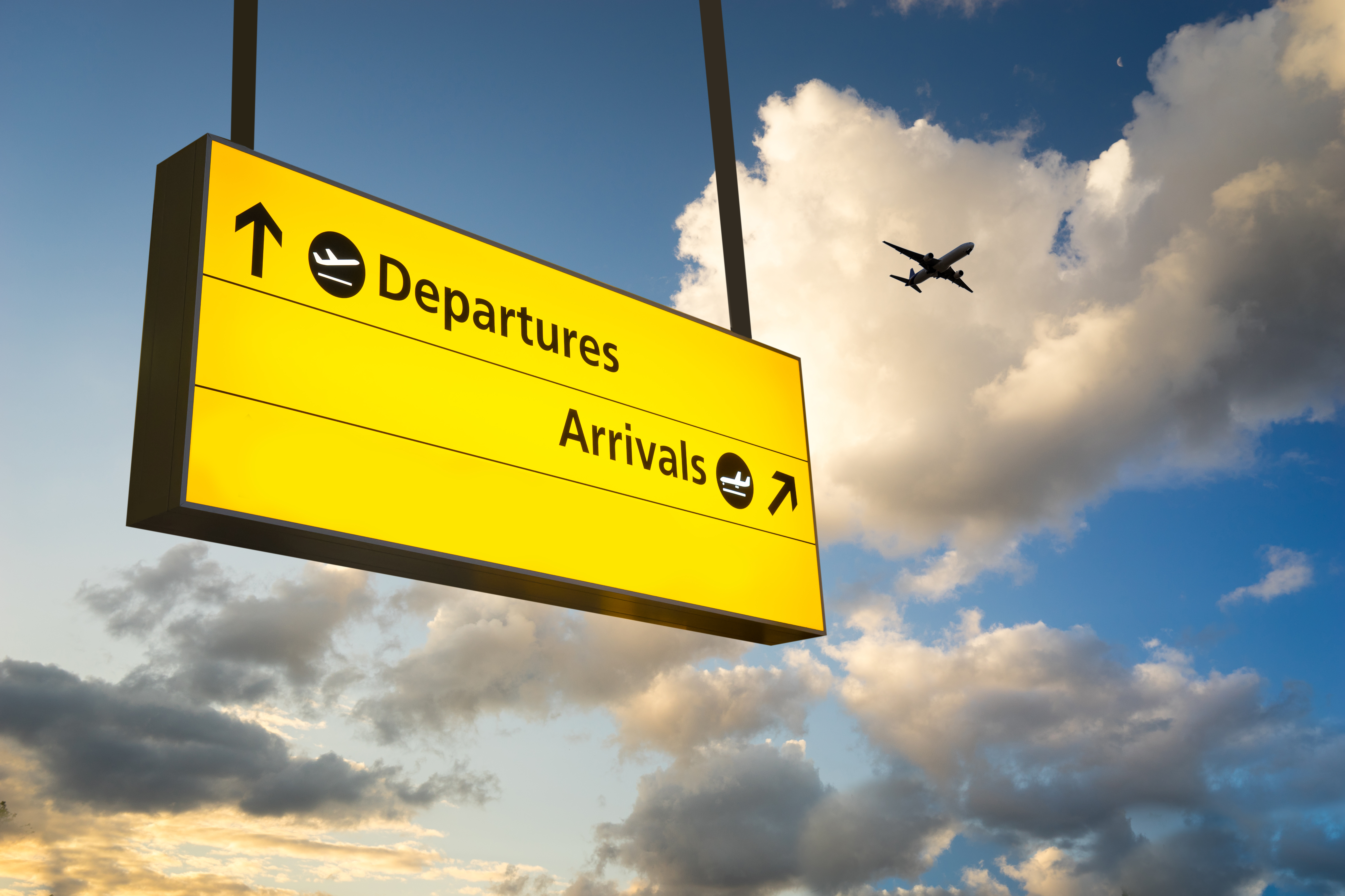 An airport sign directing visitors to arrival and departure gates