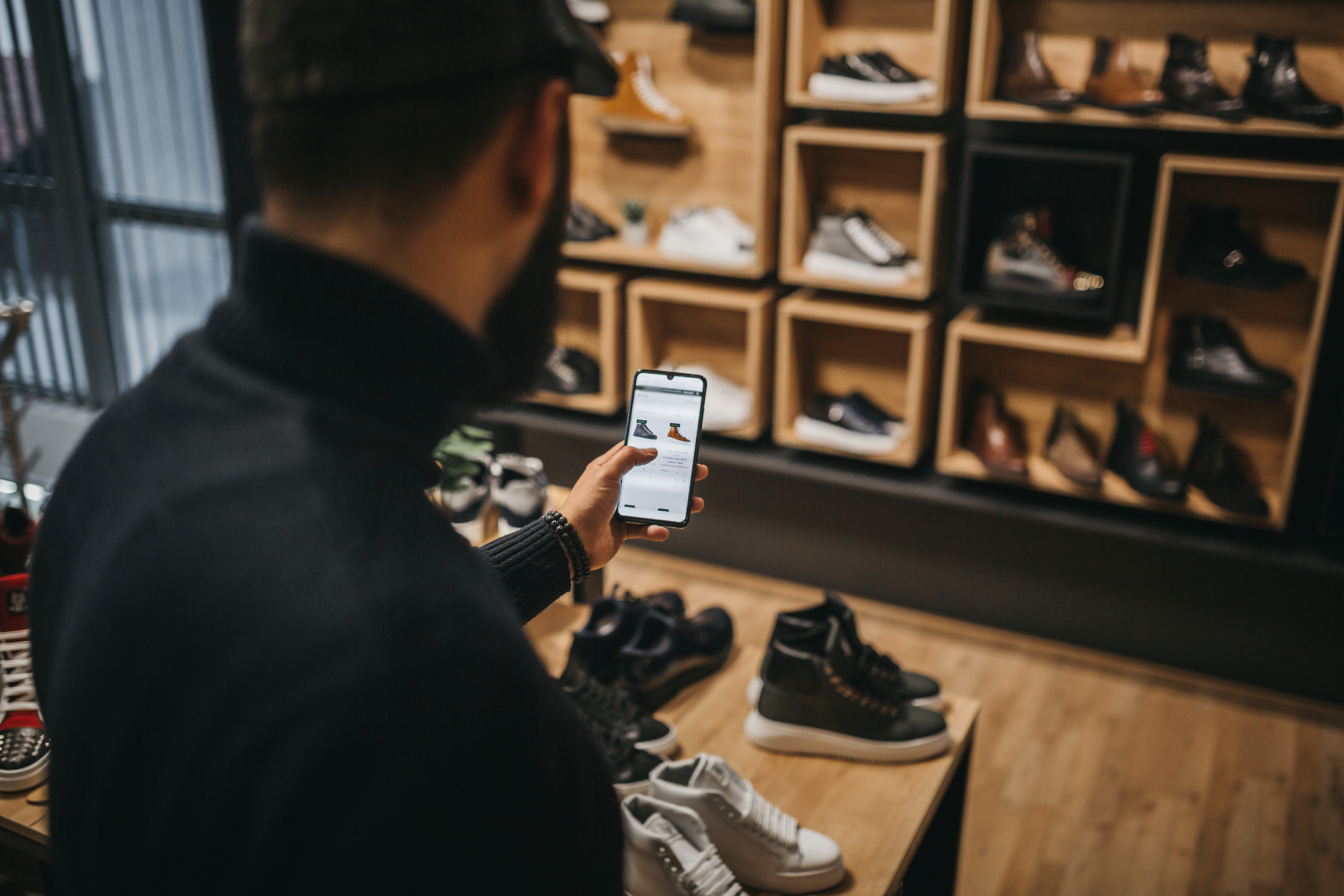Shopper comparing prices of shoes online.