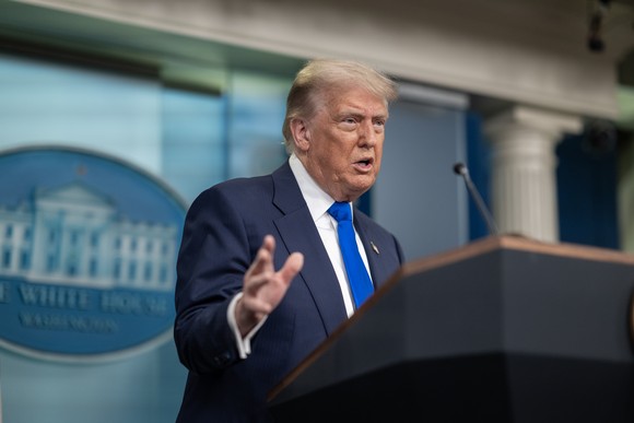 Donald Trump addressing reporters from the White House briefing room.