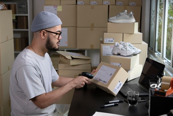 A person preparing a package for delivery.