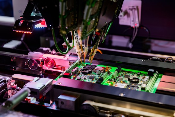 Robot creating a circuit board.