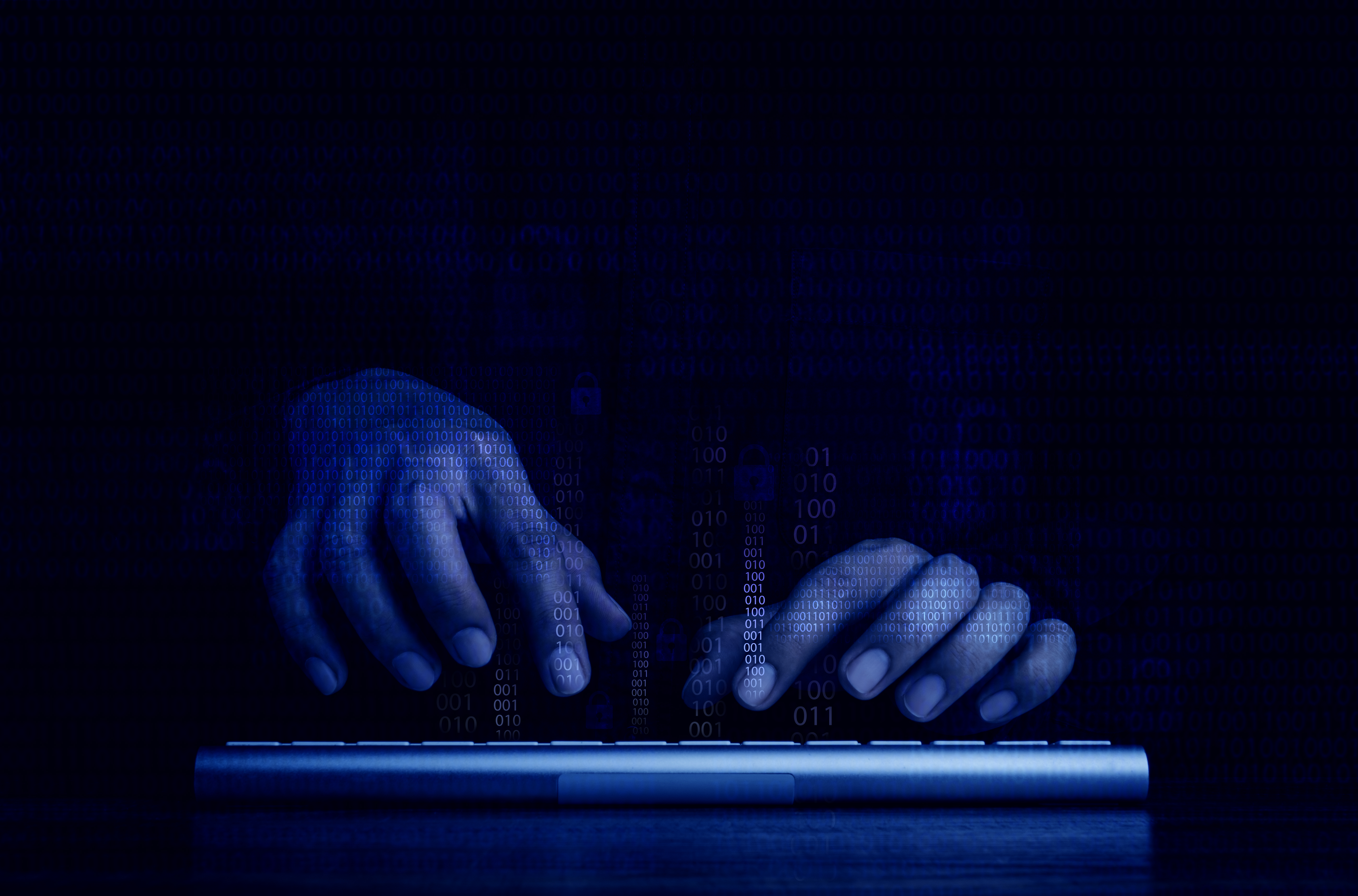 Two hands on a keyboard depicting a cyberattack