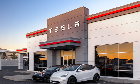 Tesla dealership with cars out front.