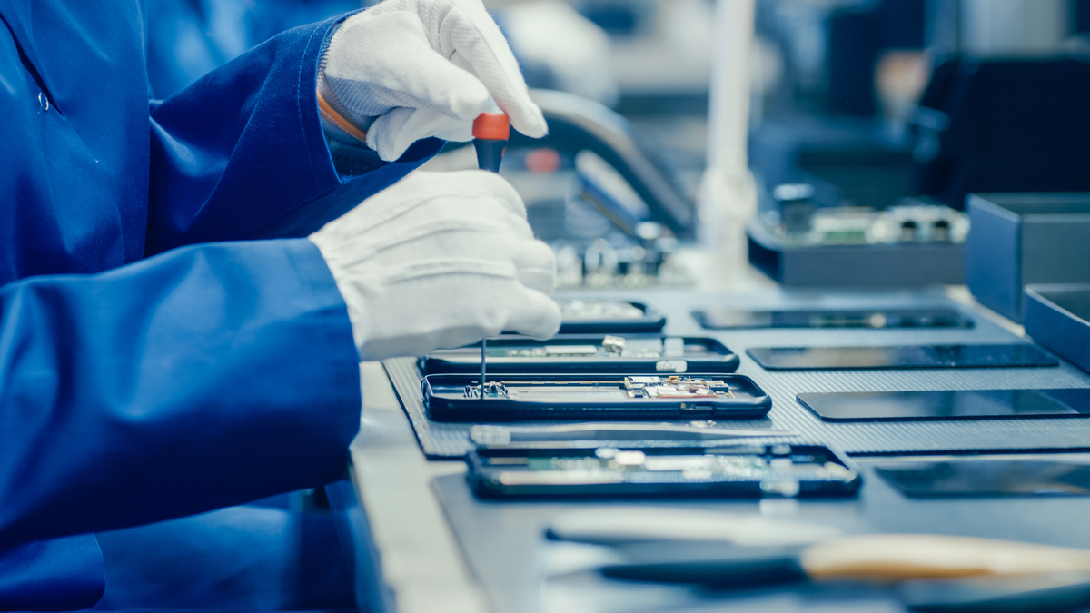 A cell phone being assembled.