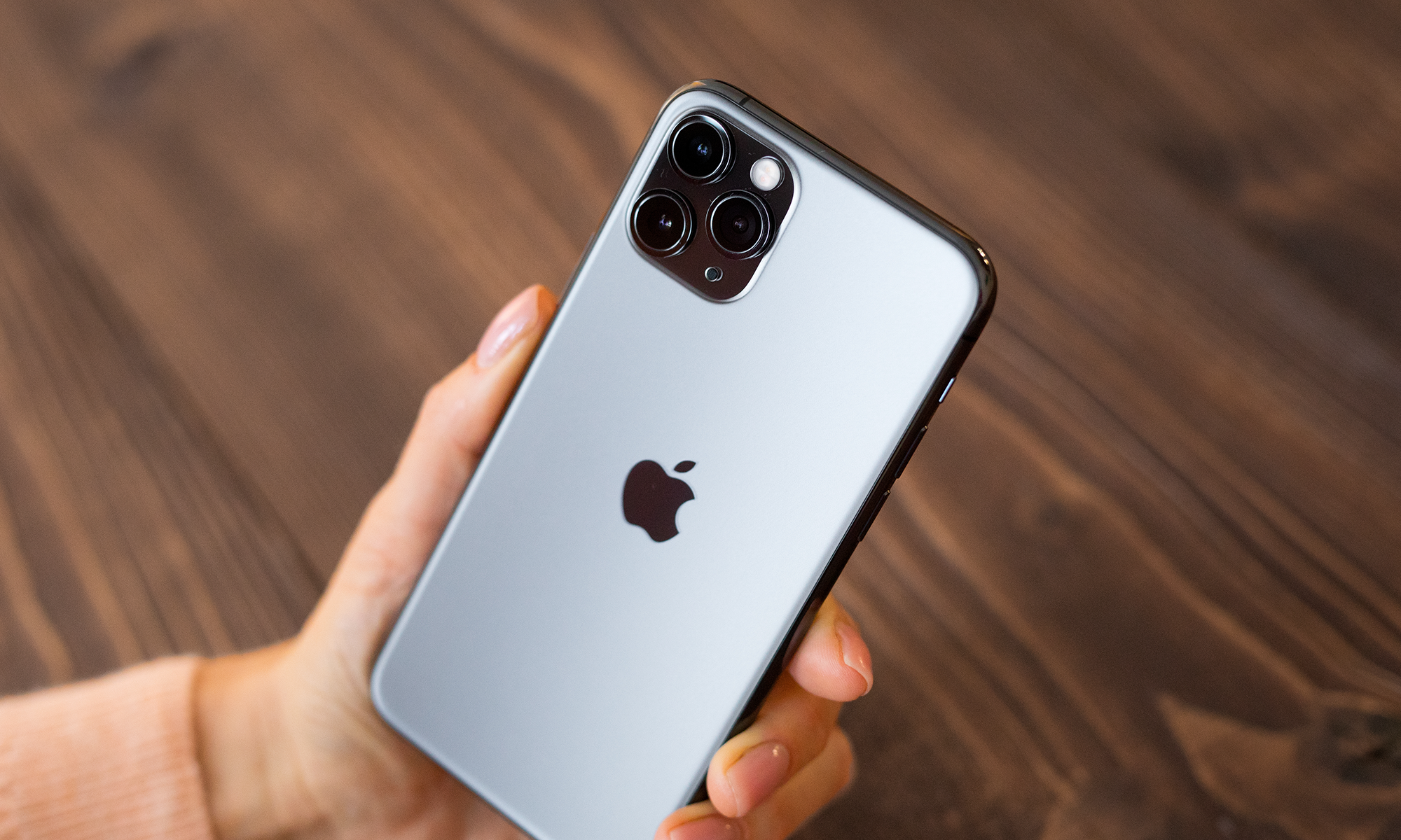 A person holds an Apple iPhone.