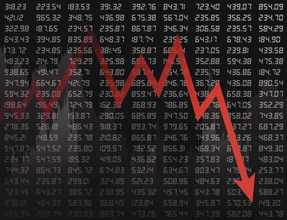 Red down arrow on a black backdrop of ticker tape prices.