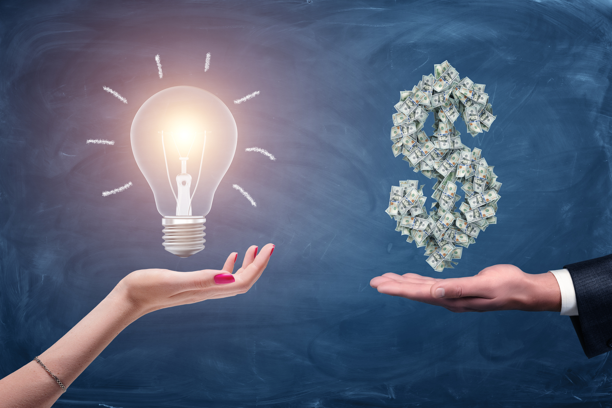 A light bulb displayed over a person's palm next to a dollar sign made up of cash displayed over another person's palm.