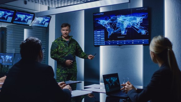 Military personnel reviewing details for a mission.