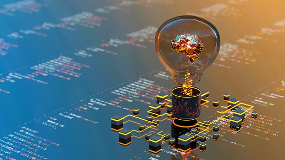 Abstract image featuring a colorful brain inside of a lightbulb on a circuit board, illustrating the power of machine learning and artificial intelligence. 