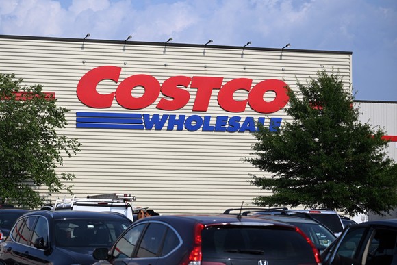 A Costco store with cars in the parking lot.