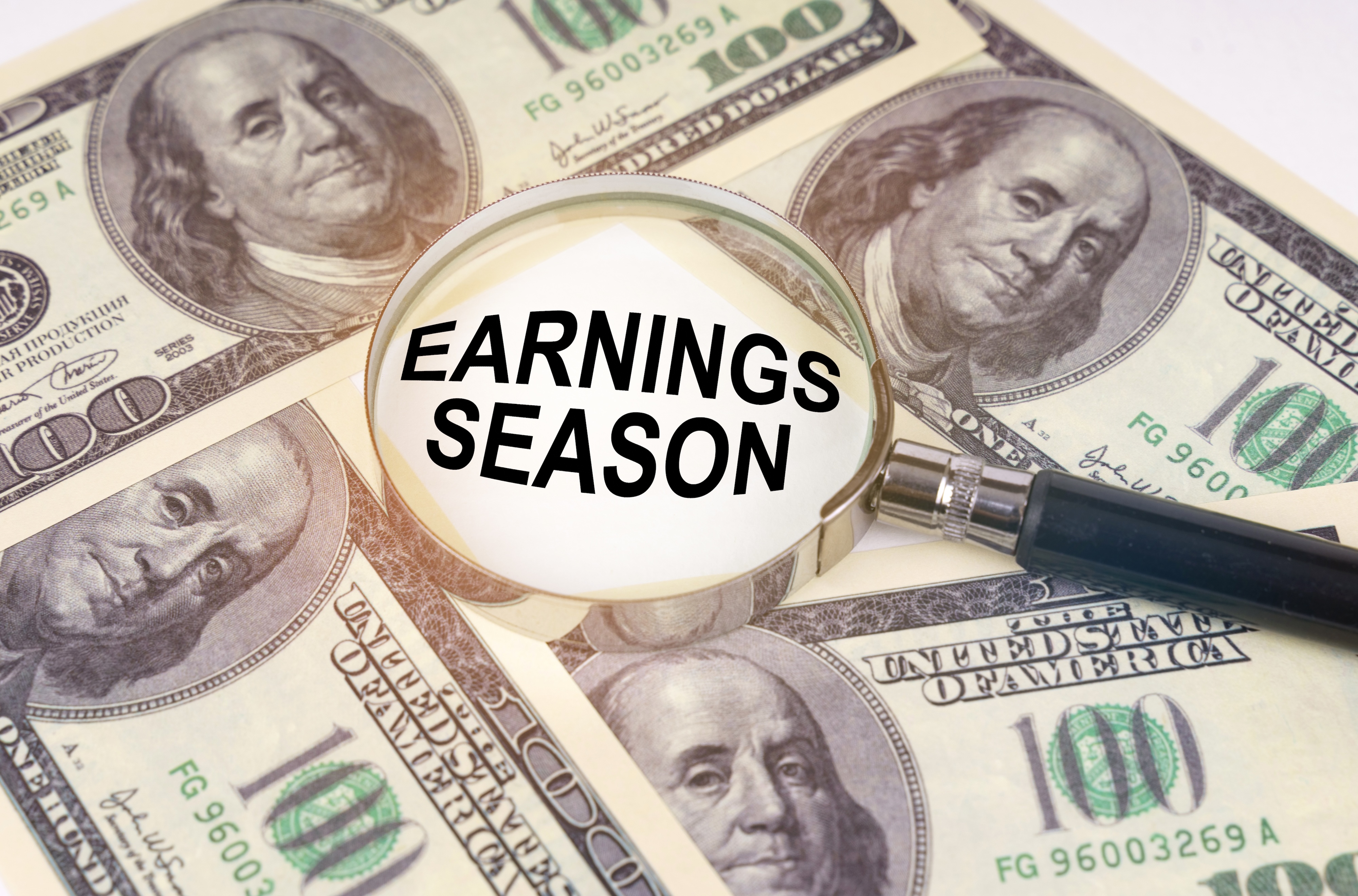 earnings season with $100 dollar bills