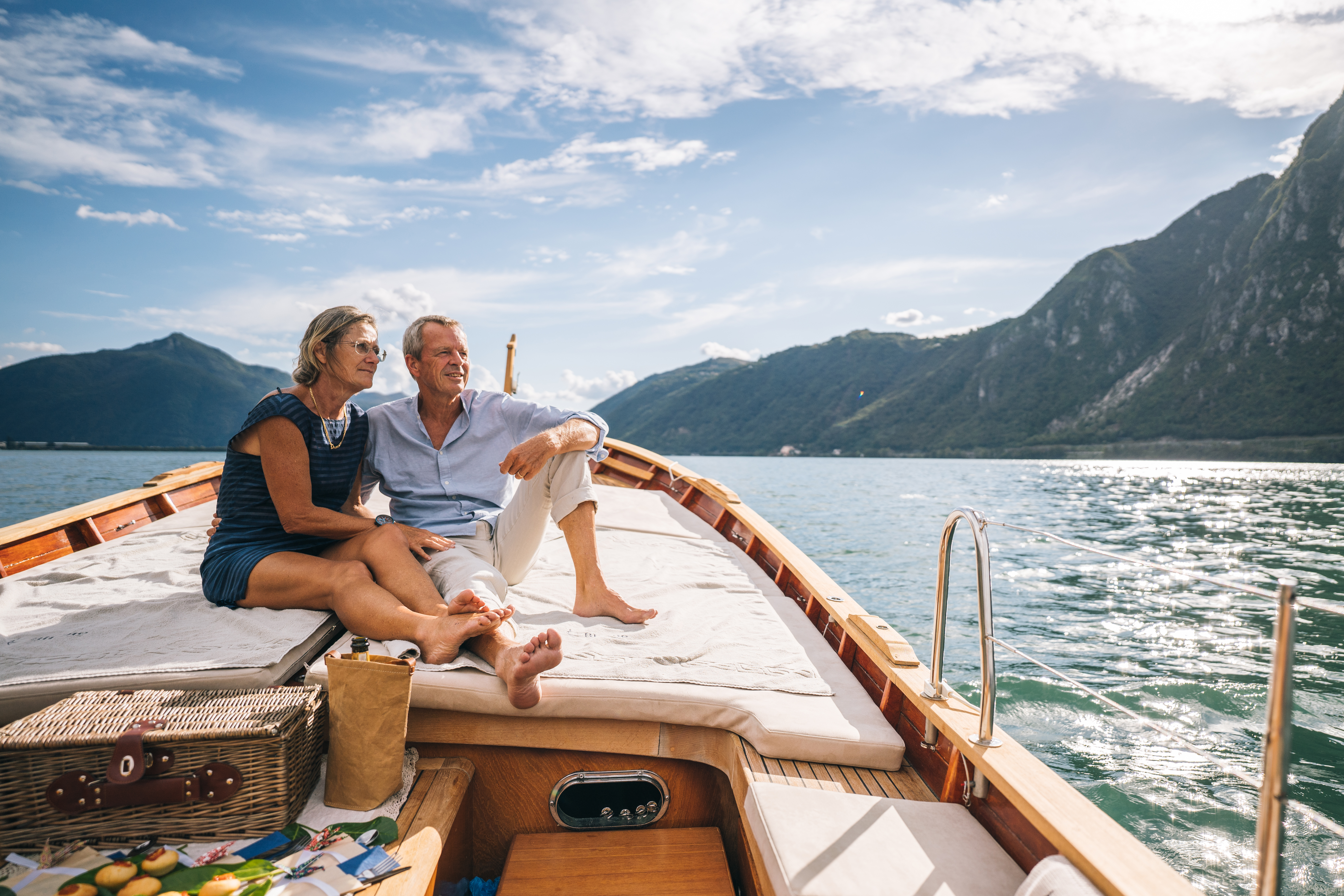 Couple sitting near the bow of a large boat.