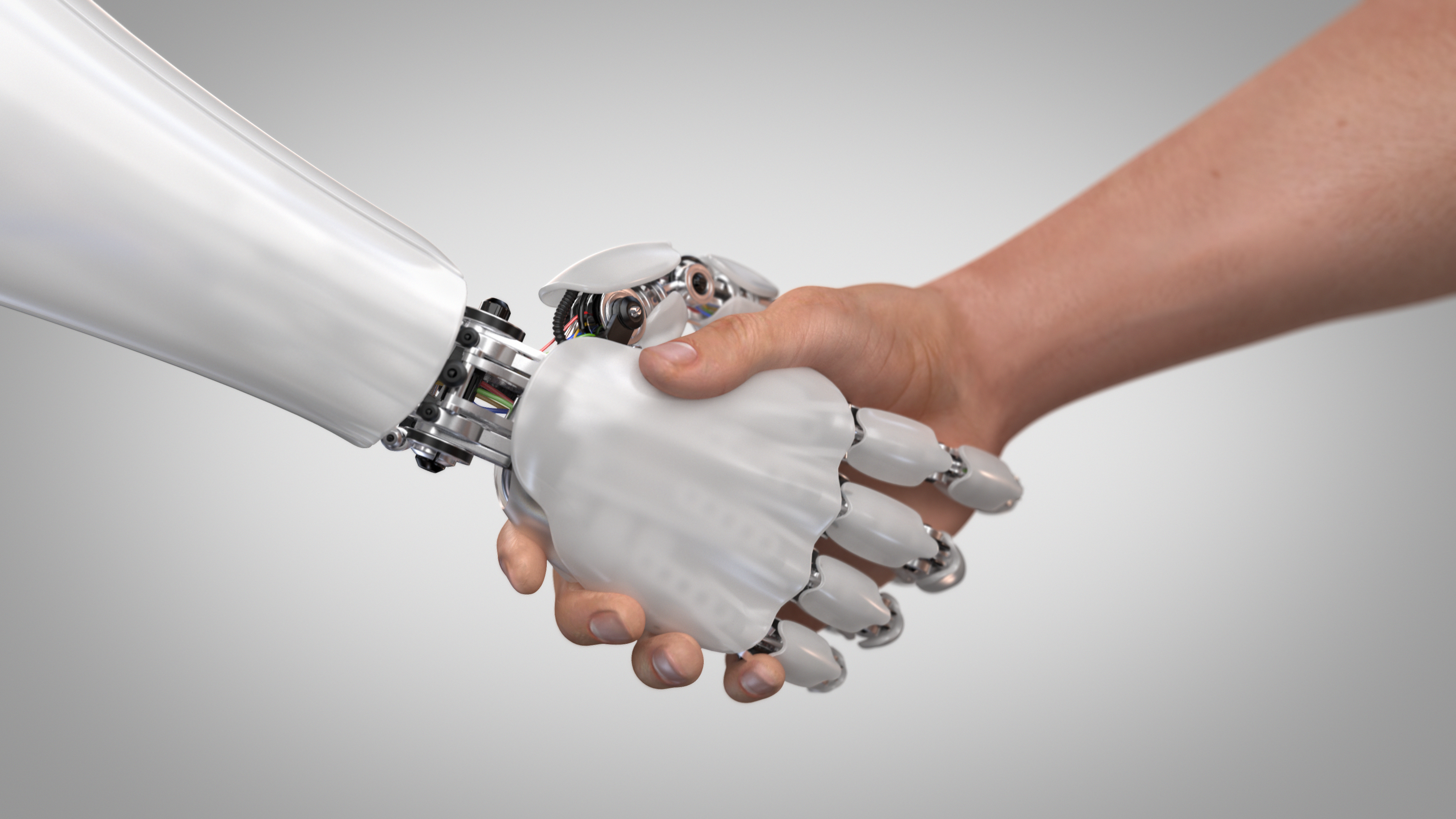 A human shaking hands with a robot.