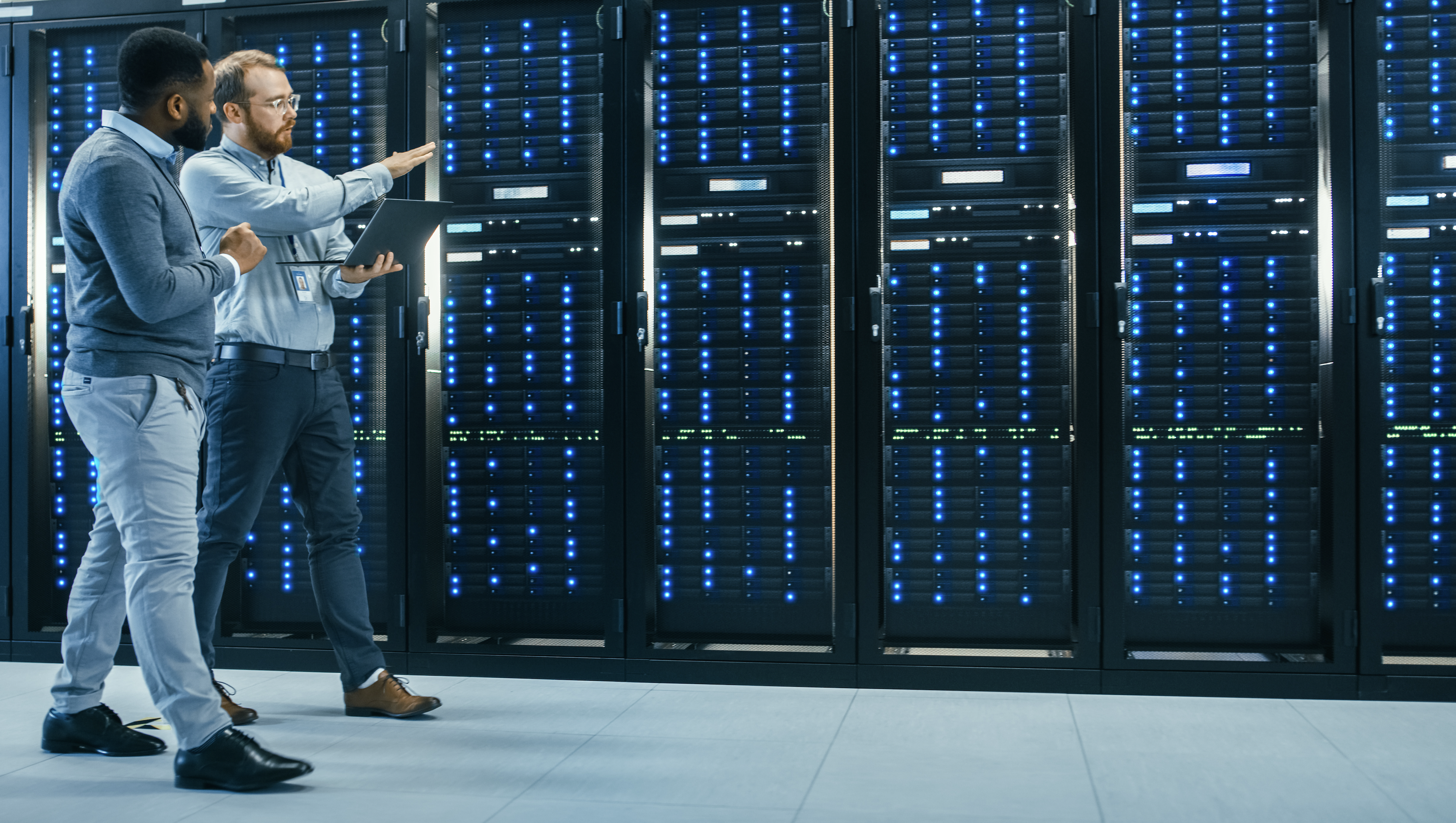 Engineers evaluating a row of servers.