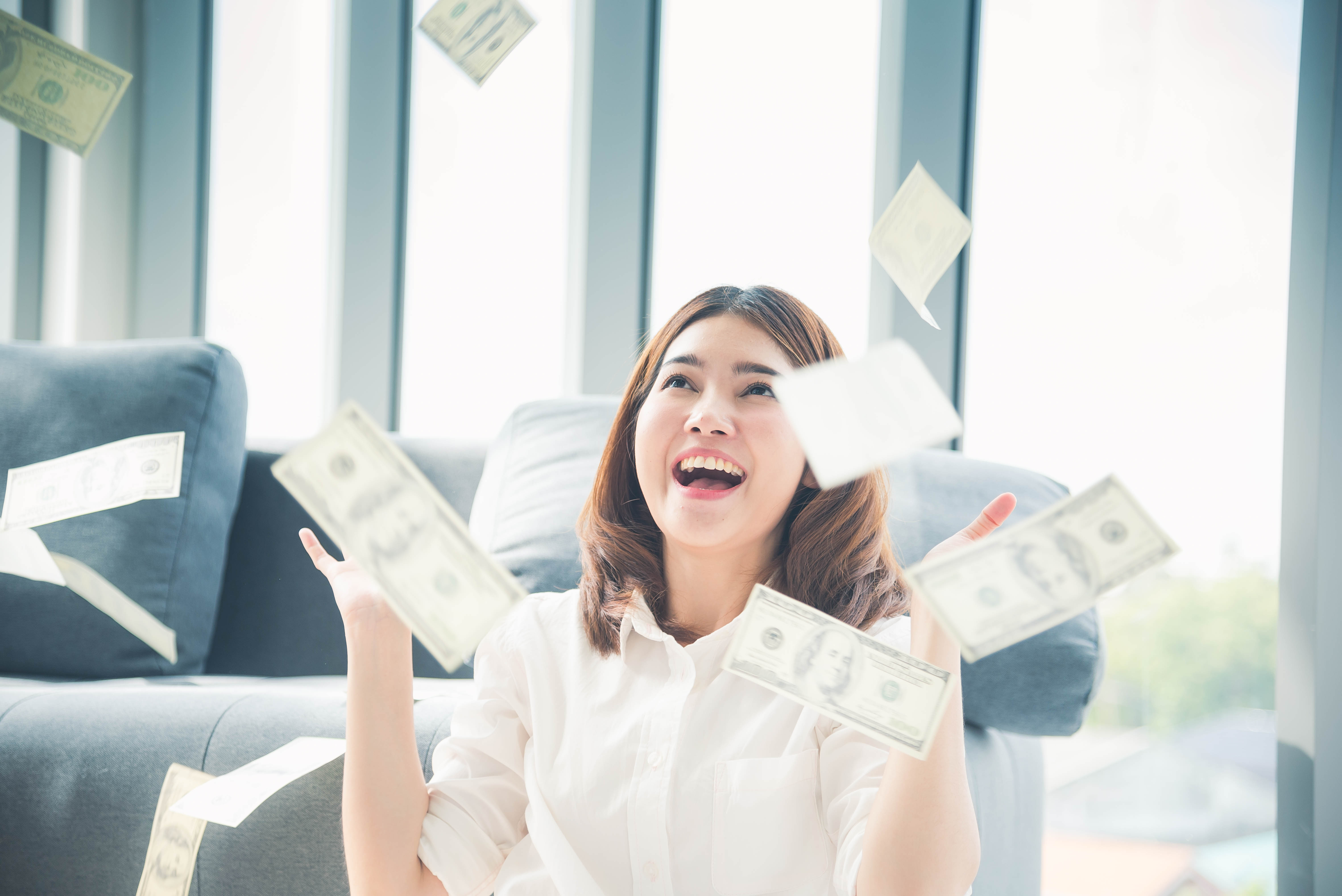 Person throwing money in the air.