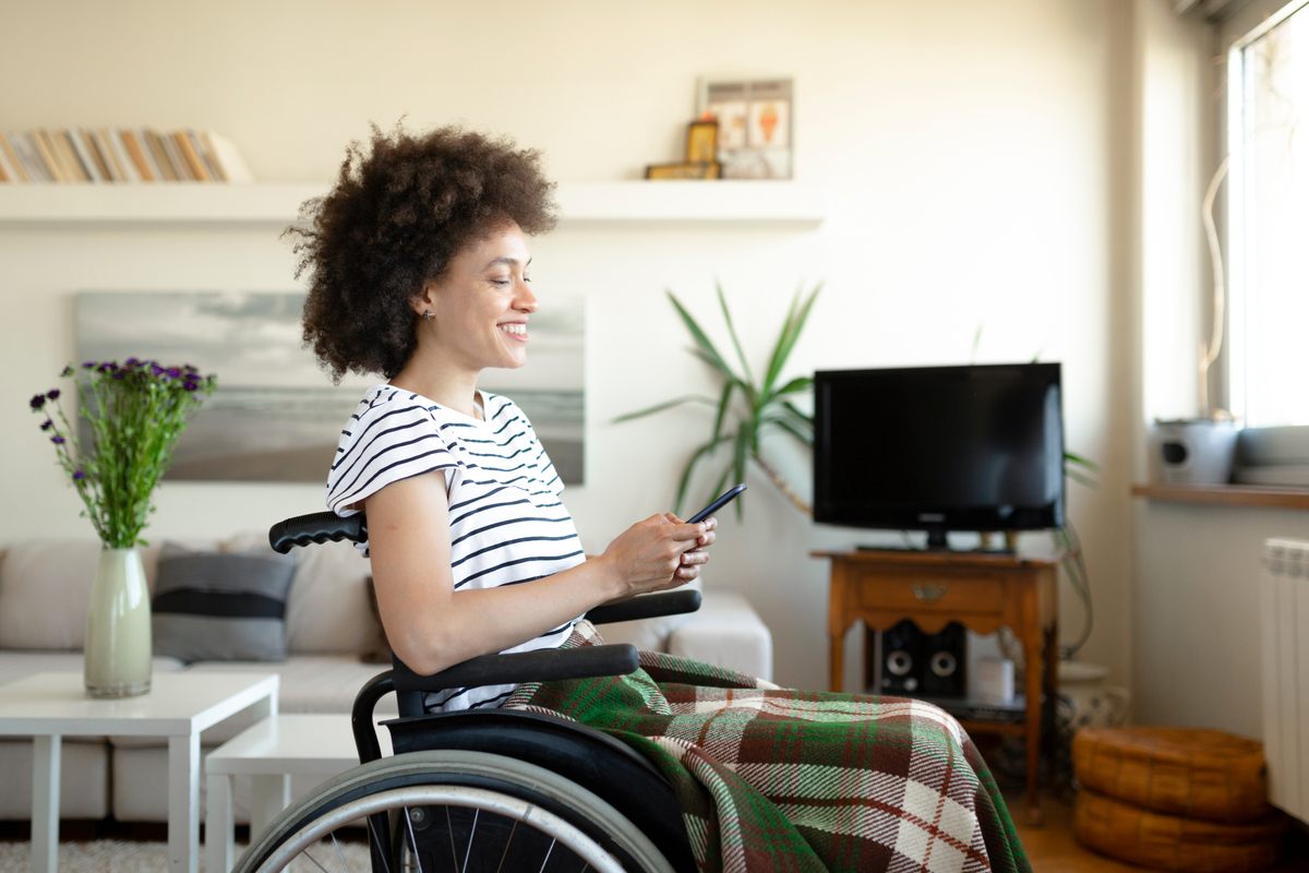 A person in a wheelchair looking at a cellphone