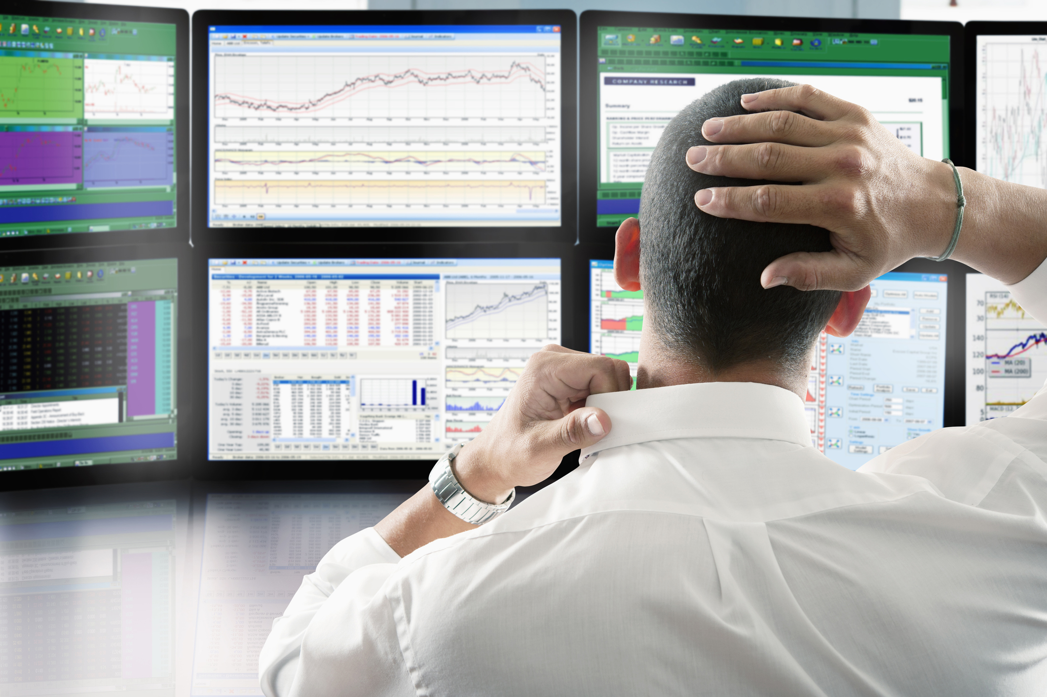 Person looking at multiple monitors.