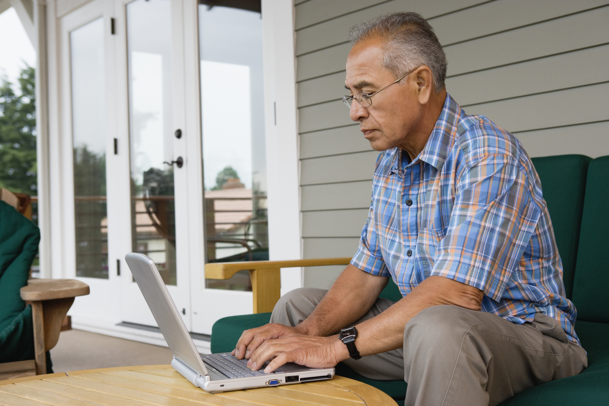 Older man laptop outdoors GettyImages-56957014