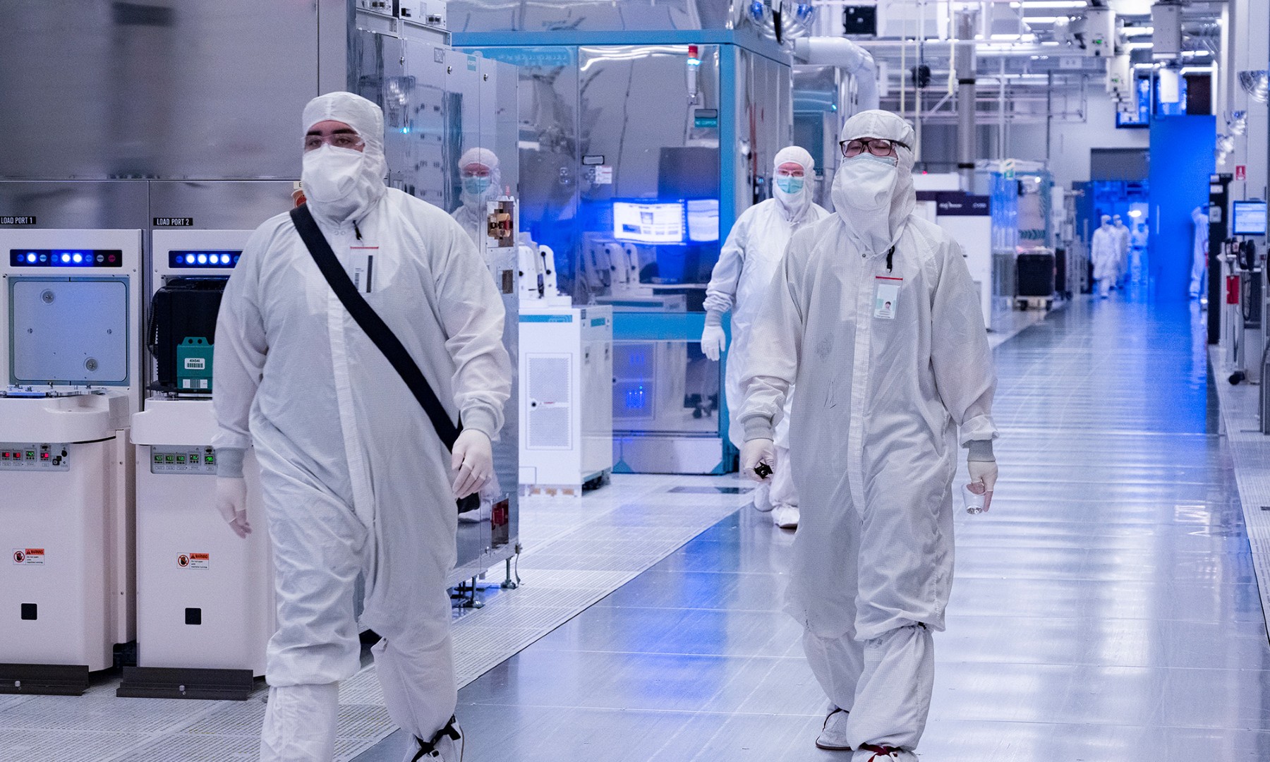 inside intel factory two people in lab gear walking_Intel