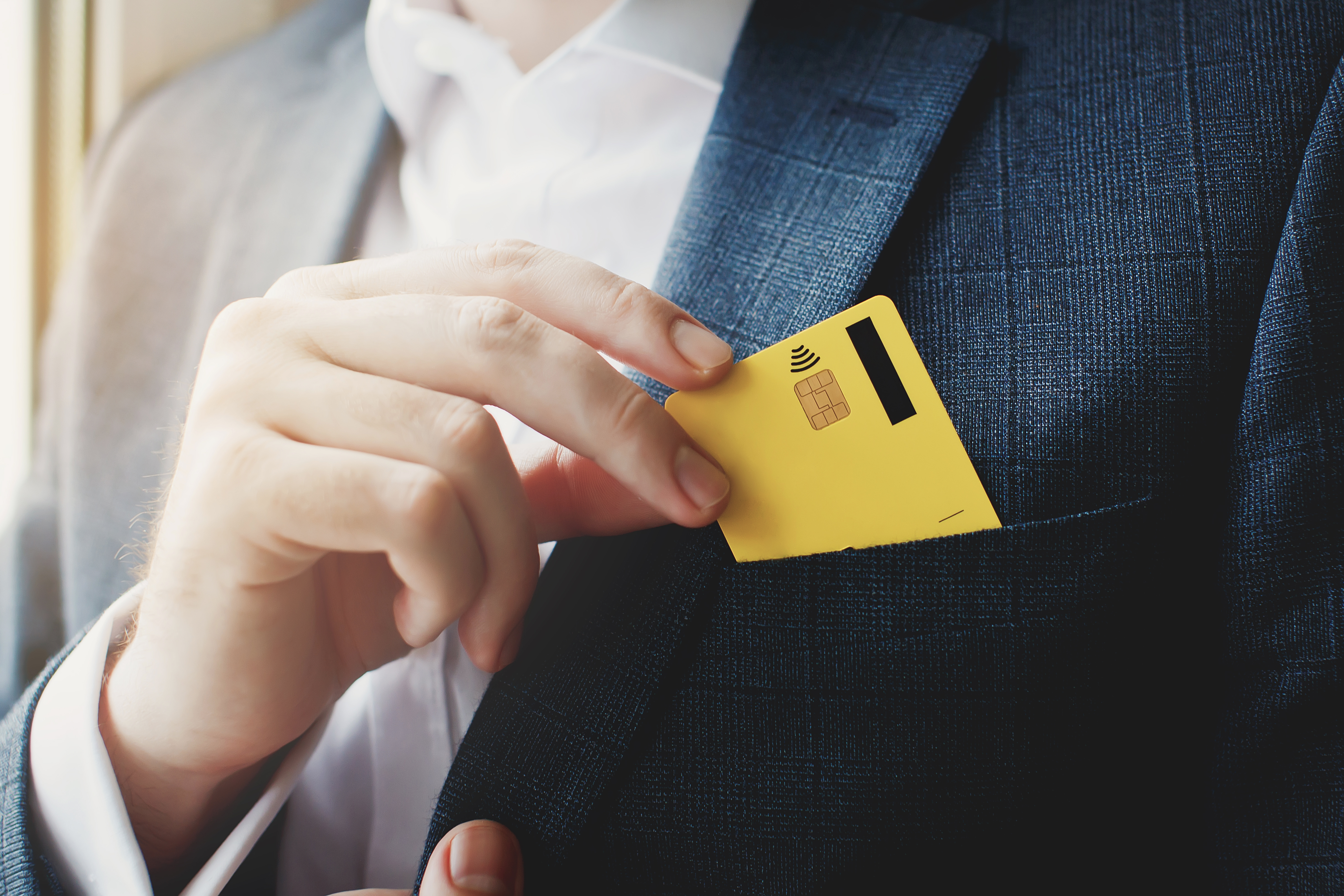 pulling credit card from front jacket pocket