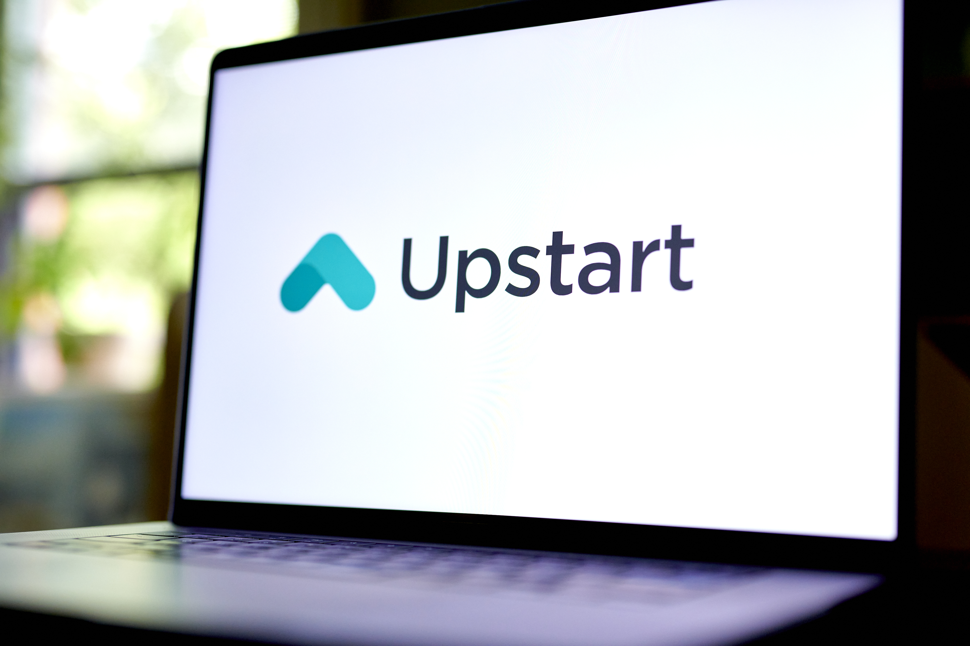 The Upstart logo displayed on a laptop screen