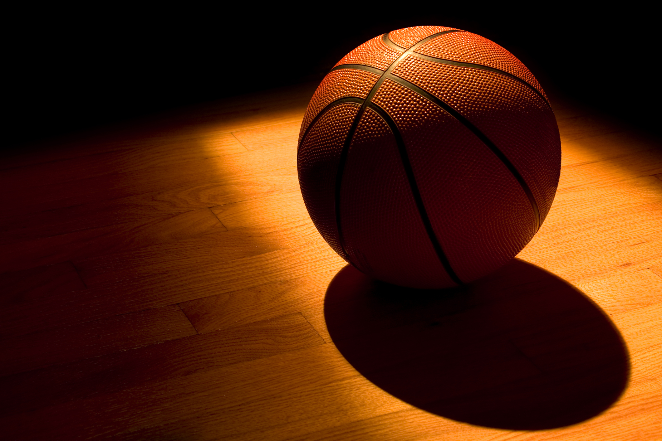 A basketball in a ray of sunlight