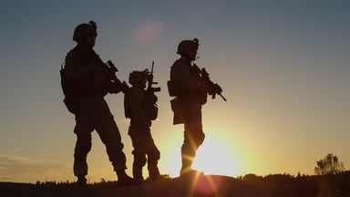 3 soldiers in silhouette