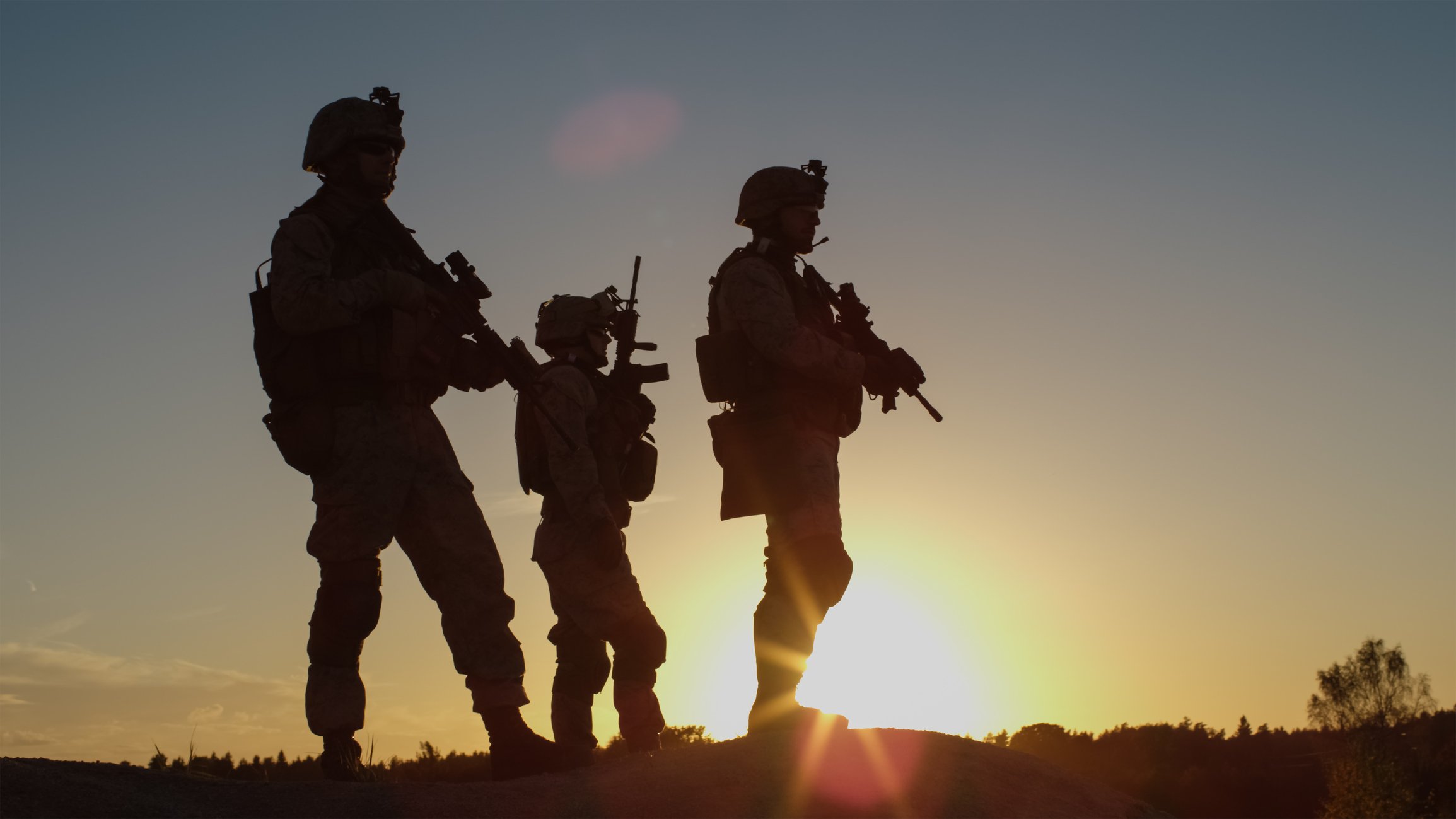 Three soldiers in silhouette.