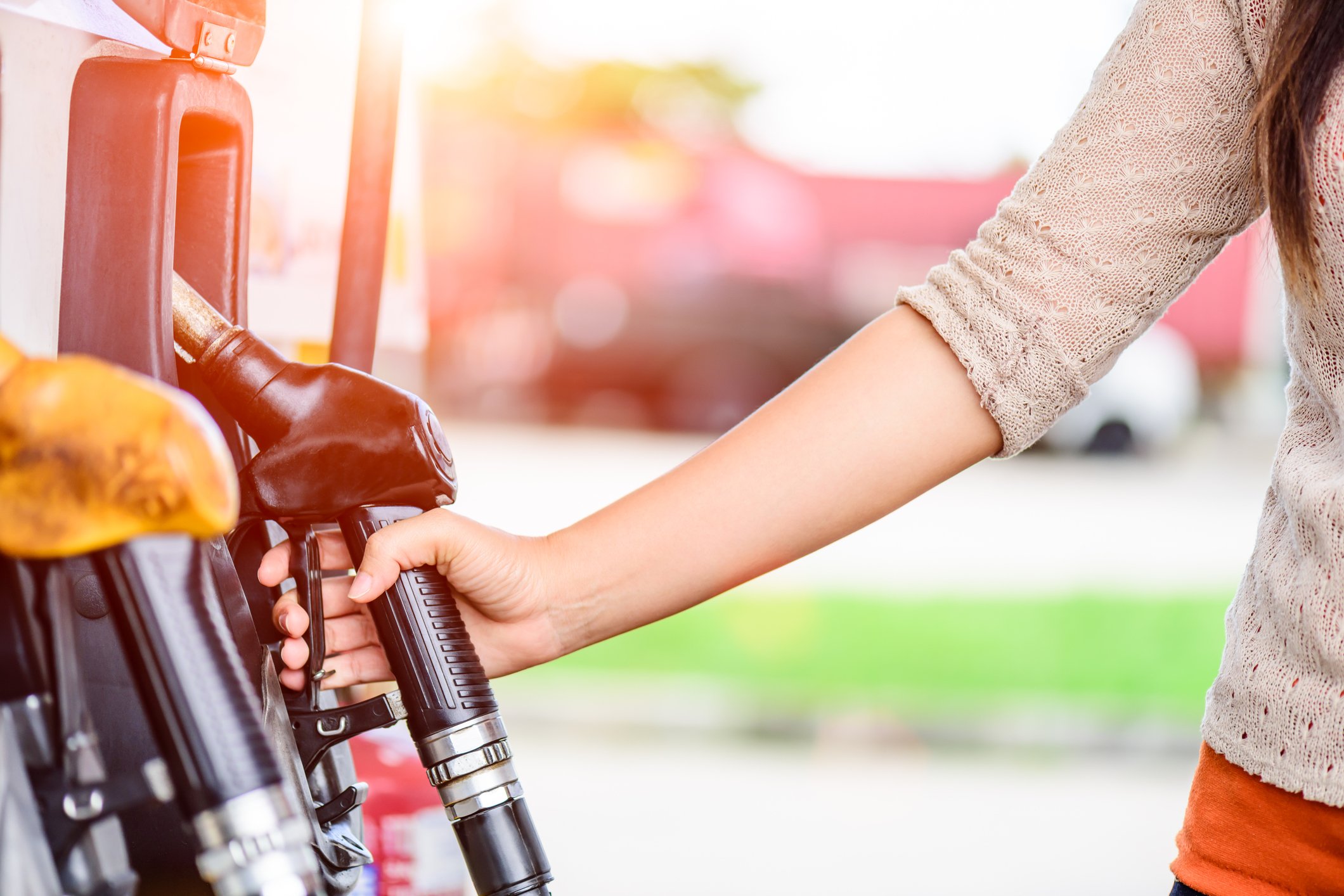 Woman holding gas pump
