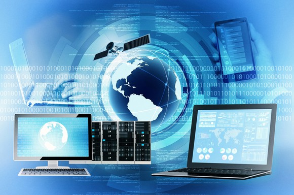 Various computers, a smartphone, and a satellite shown over a blue and white background of 0s, 1s, and the earth