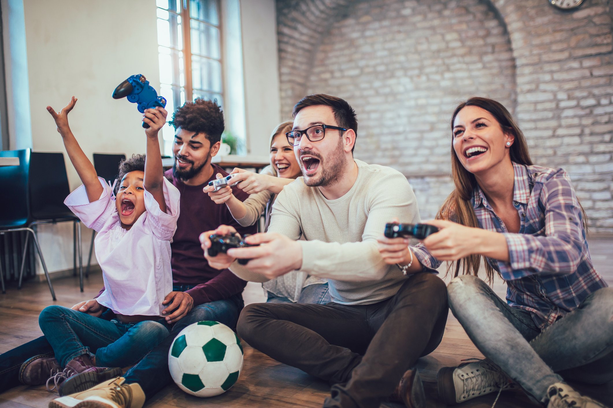 A family excitedly playing video games in the living room