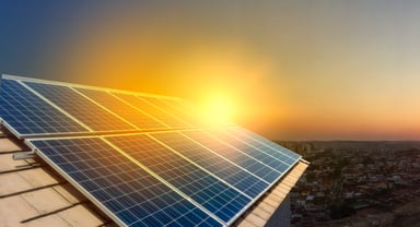 solar power panels on a roof at sunset