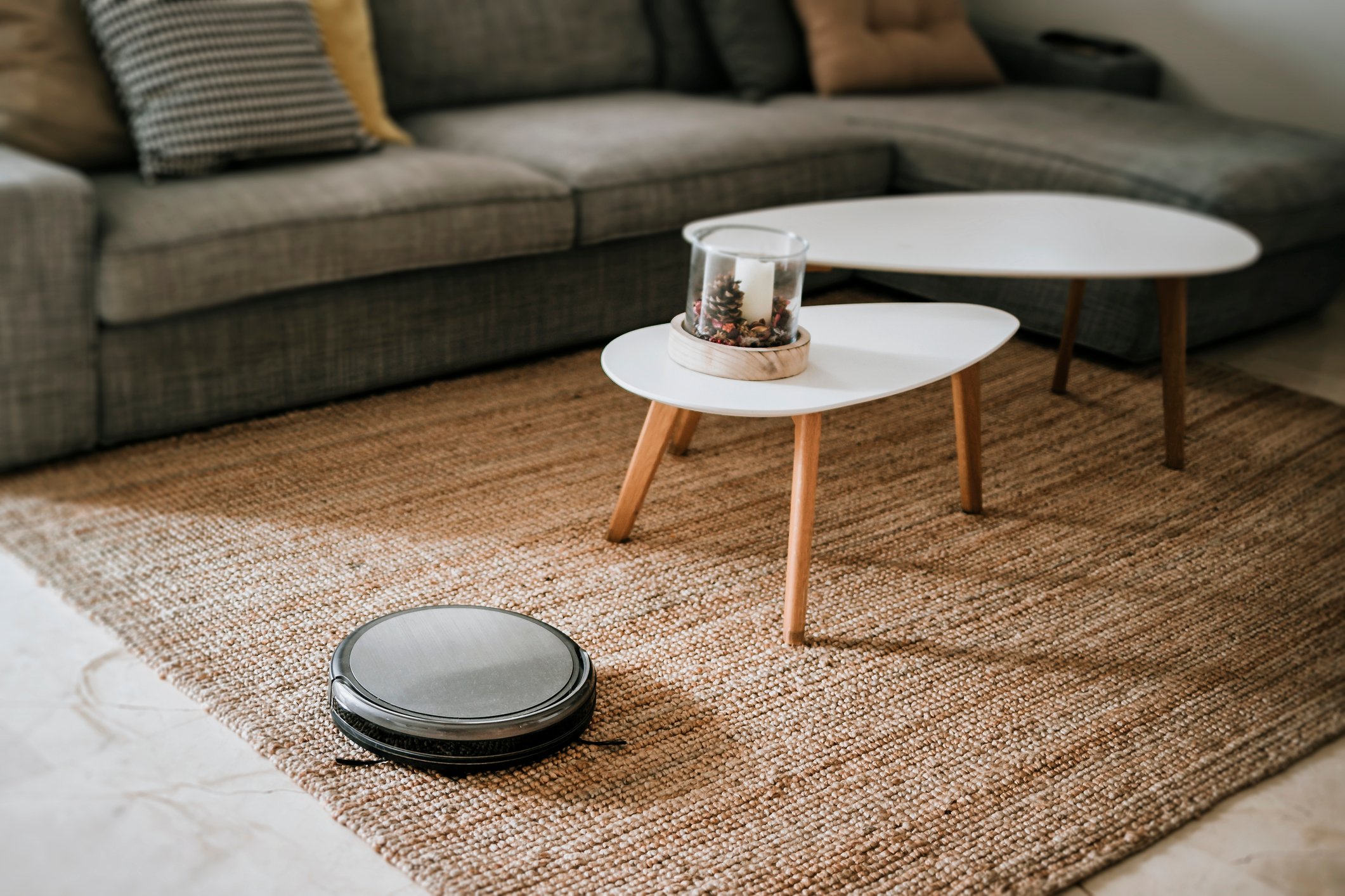 A robotic vacuum working on the floor in a living room