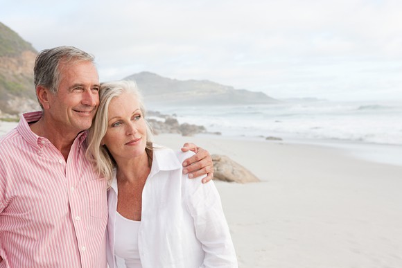 Retired couple on beach.