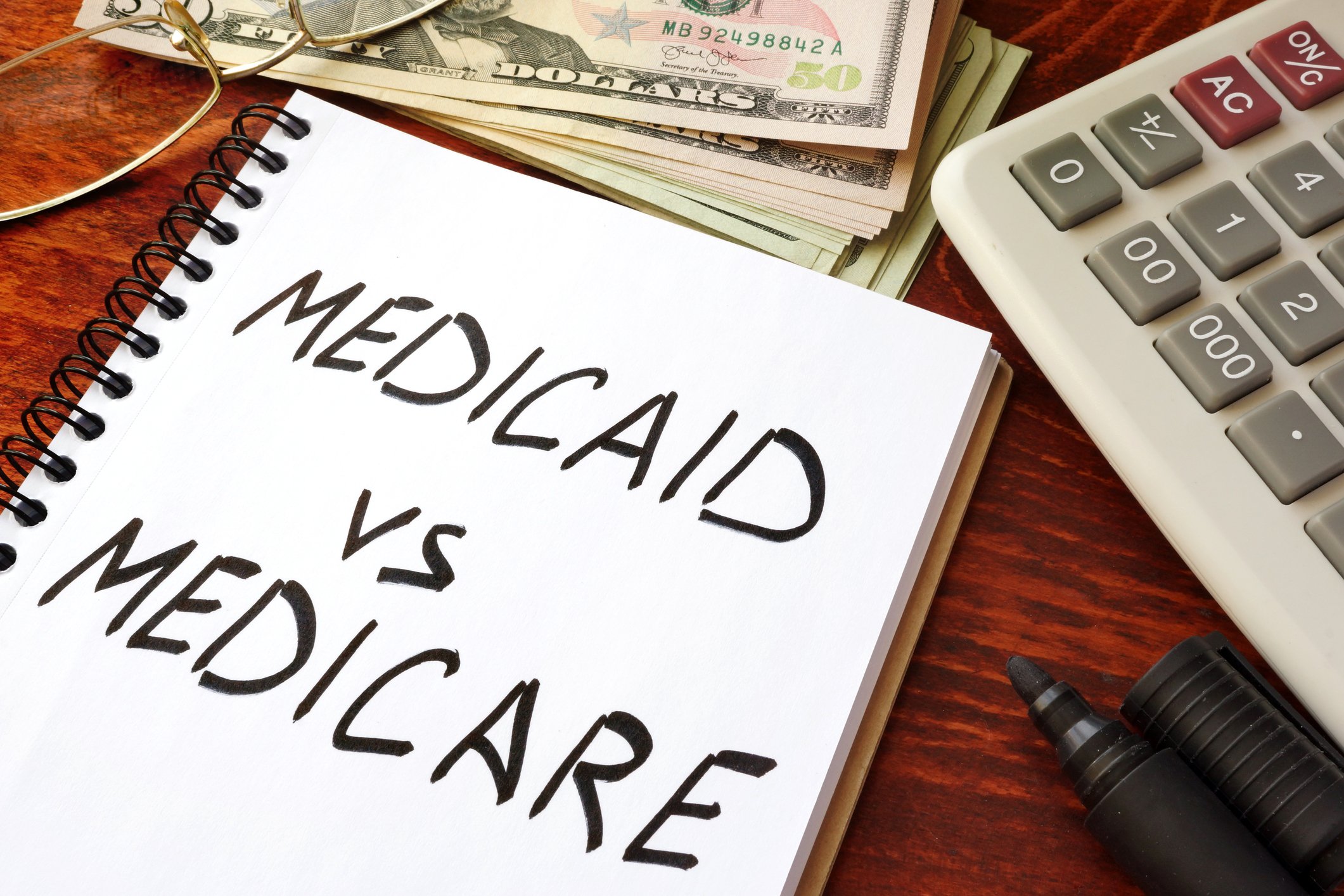 Medicaid vs. Medicare on a notepad