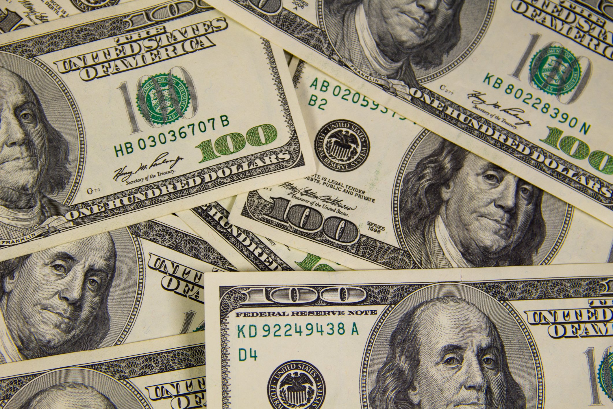 Hundred dollar bills scattered.