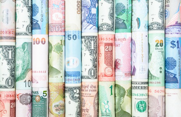 Rolled up bills from different currencies around the world