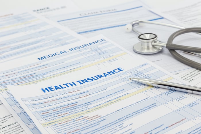 Health insurance form with stethoscope and silver pen on top