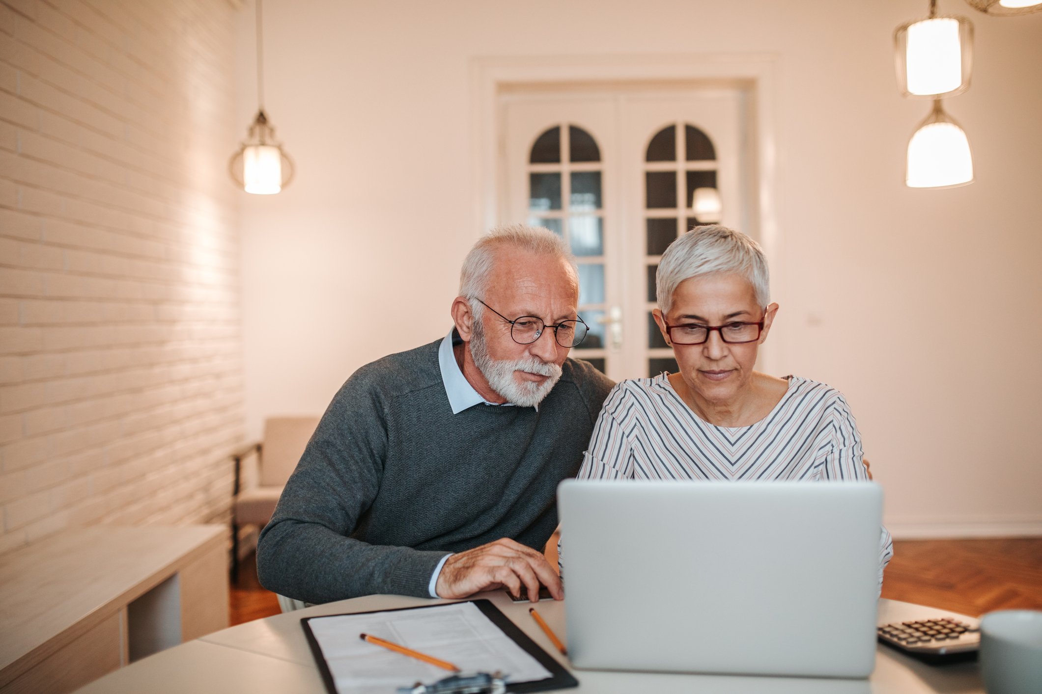 Elderly couple looking at laptop
