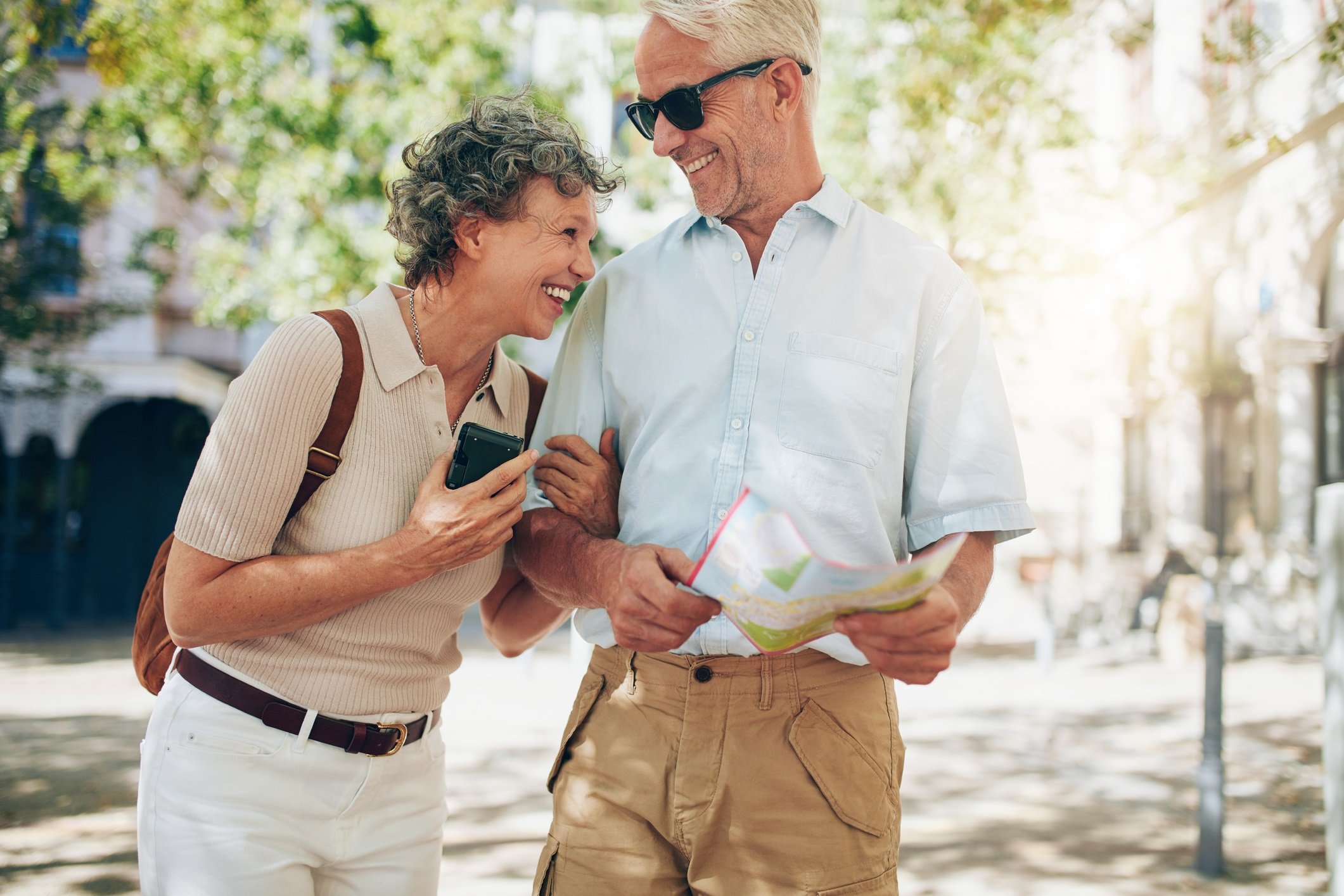 Retired couple laughing while walking around town