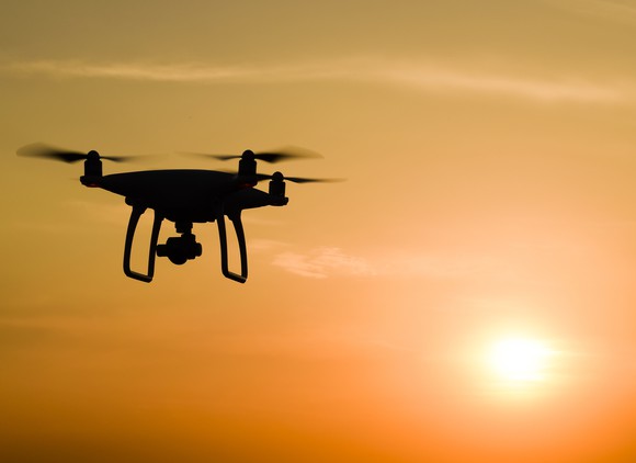 Silhouette of a drone with sun setting in the background