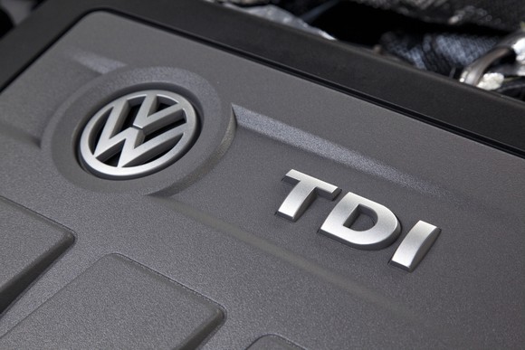 A closeup of the engine cover on a 2.0-liter VW turbodiesel engine, showing the VW brand logo and the initials "TDI"
