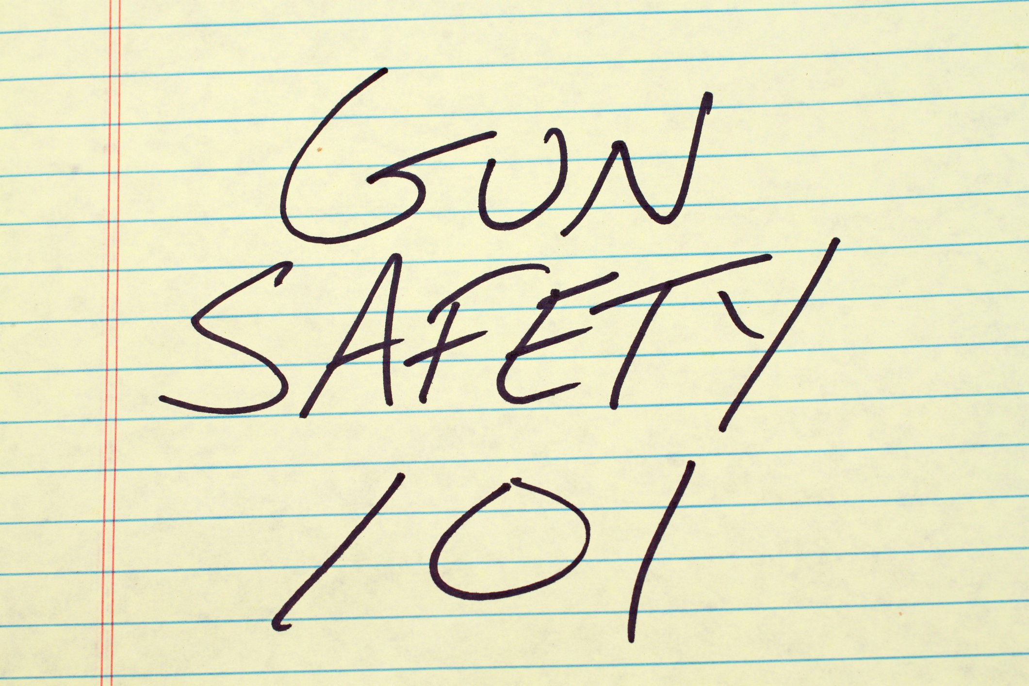"GUN SAFETY 101" written in black on yellow lined paper
