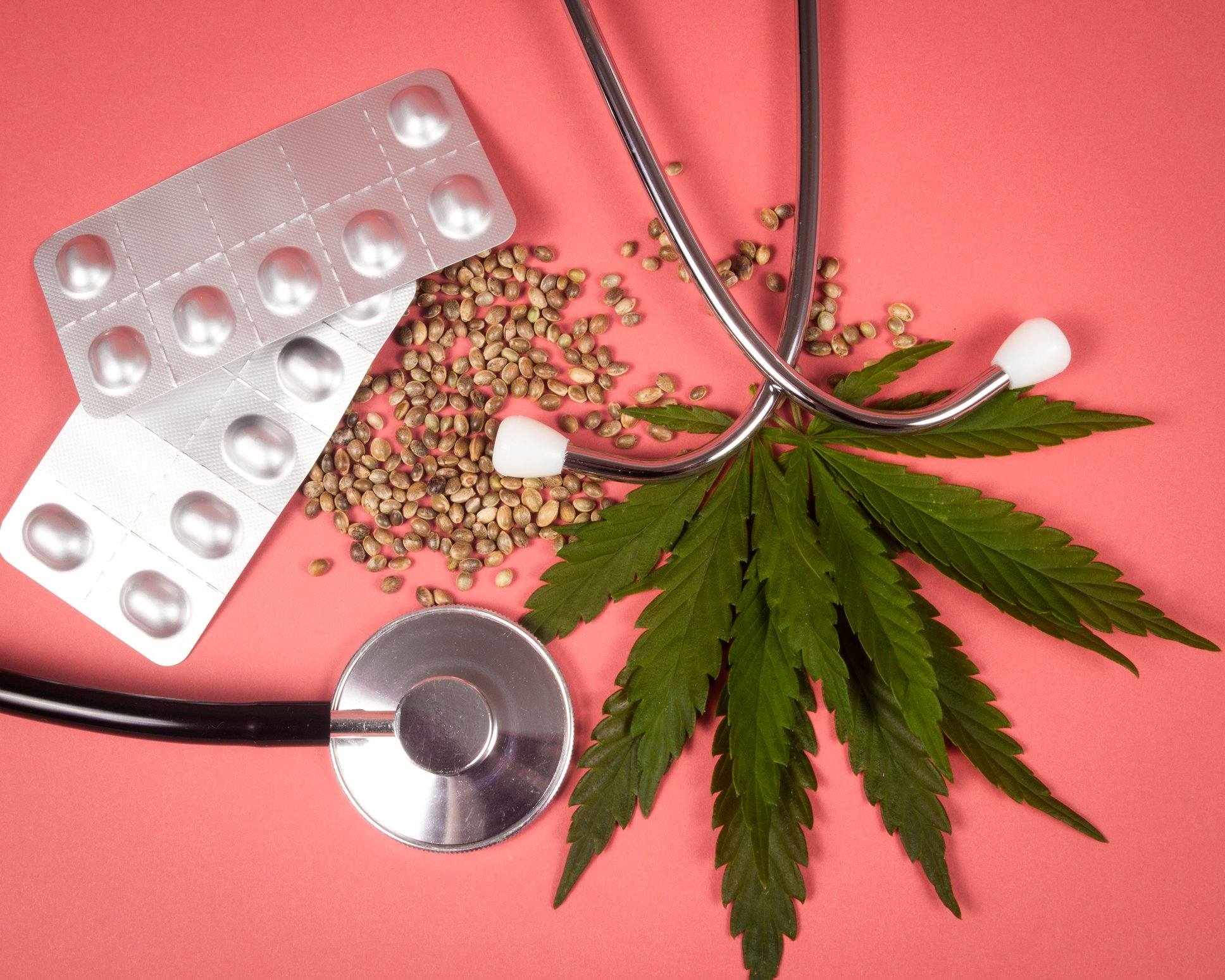 A cannabis leaf with a stethoscope and pill packet