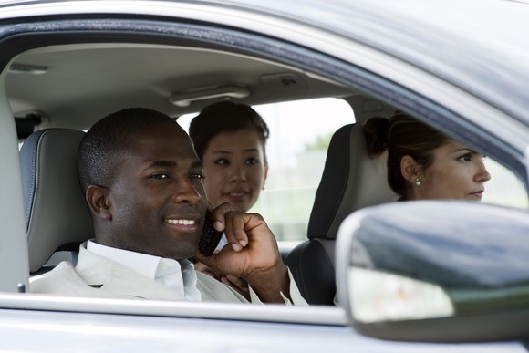 Several people share a ride in a car.